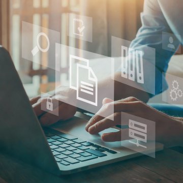 Computer icons floating over a laptop